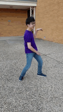 a young man wearing a purple shirt that says tmsf