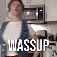 a woman dancing in a kitchen with the words wassup written on the bottom