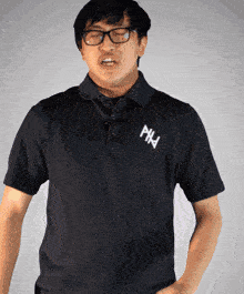 a man wearing glasses and a black shirt with phd written on it