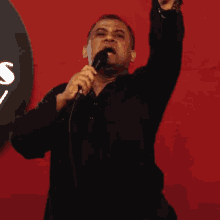 a man is holding a microphone and making a funny face .
