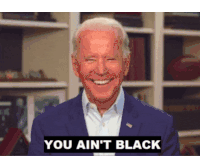 a man in a suit is smiling with the words you ain 't black above him