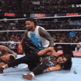 a man wearing a shirt that says eat sleep wrestling a woman