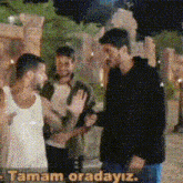 a group of men standing next to each other with the words " tamam oradayiz " in the bottom right corner