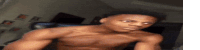 a shirtless young man is taking a selfie in a room .
