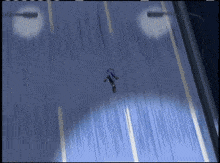 a person in a blue suit is walking down a street at night