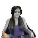 a woman wearing headphones and a purple tank top is sitting at a table with her eyes closed .