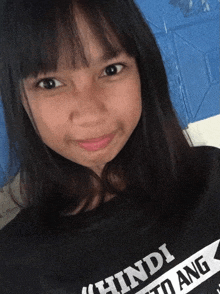 a girl wearing a black shirt that says hindi dito ang