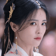 a close up of a woman 's face wearing a headpiece