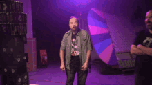 a man wearing a t-shirt that says ' guns n ' roses ' gives the middle finger