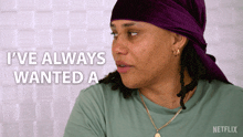 a woman wearing a purple head scarf says i 've always wanted a netflix logo in the corner