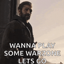 a man with a beard is holding a gun and saying wanna play some warzone lets go .