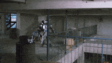 a man in a robot costume is walking down a staircase