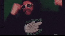 a man wearing sunglasses and a shirt that says no gloves