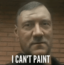 a man with the words i can 't paint written on his face