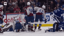 a hockey game is being played in front of a coffe advertisement
