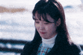 a woman is crying while wearing a plaid dress