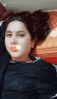a woman with a cigarette in her mouth is laying down