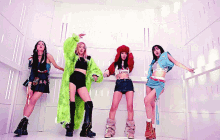 a group of women are standing next to each other in a room .