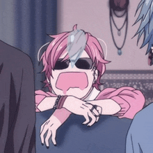 a girl with pink hair is wearing sunglasses and a wristband