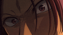 a close up of a person 's eyes with a red hair