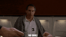 a man with a spoon in his shirt is being held by someone with the words oh cooli written on the bottom