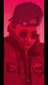 a man wearing sunglasses and a hat with the words " suupuaah tight " on the bottom