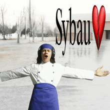 a chef wearing headphones stands in front of sybau