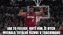 a basketball player in a red jersey with the number 6 on it is celebrating a basket .