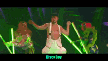 a man is dancing on a stage with disco boy written below him