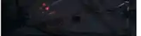 a white car is driving on a highway at night .
