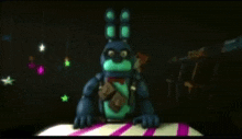 bonnie the bunny from five nights at freddy 's is sitting on a table in a dark room .