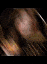 a blurry picture of a person 's face with a blurred background