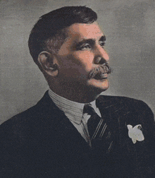 a black and white photo of a man in a suit