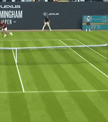 a man swings a tennis racquet in front of a sign that says lexus birmingham open