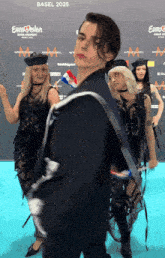 a group of people are standing in front of a blue carpet that says eurovision on it