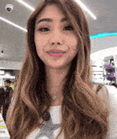 a woman wearing a necklace with a star on it looks at the camera