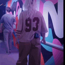 a woman wearing a jersey with the number 93