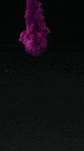 a close up of a pink and red ink explosion