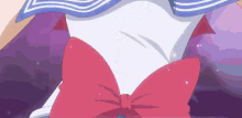 a close up of a person wearing a sailor suit with a red bow .