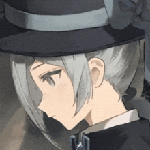 a close up of a person wearing a hat with a letter m on it