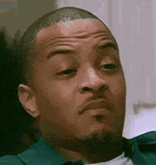 a close up of a man making a funny face .