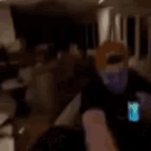 a blurry picture of a living room with a person standing in the corner .