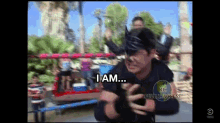 a man in a boxing ring says i am in front of a roller coaster