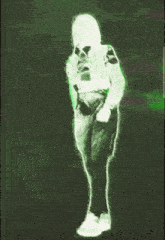a green glowing image of a person standing on a green background