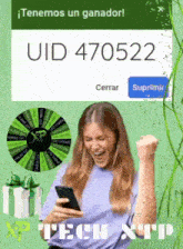 a woman is holding a cell phone in front of a uiid 470522 sign