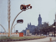 a statue of a tractor is hanging from a pole in front of a sign that says steme landwirtschaft