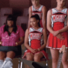 a group of cheerleaders wearing red and white uniforms with the word cars on them