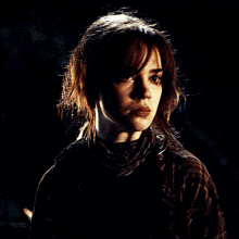a close up of a woman 's face in the dark