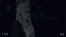 a close up of a woman 's face in a dark room .