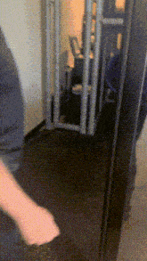 a person is standing in front of a door that has a grid pattern on it